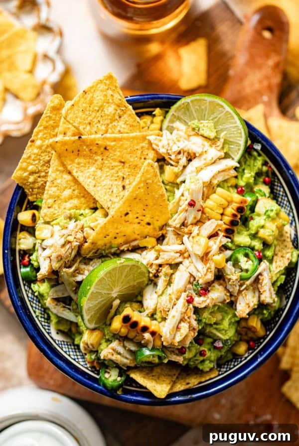 Mango Habanero Salsa Recipe — Sweet Heat with Fresh Mango 9 crab guacamole in a bowl garnished with lump crab meat, tortilla chips, cilantro, and corn.