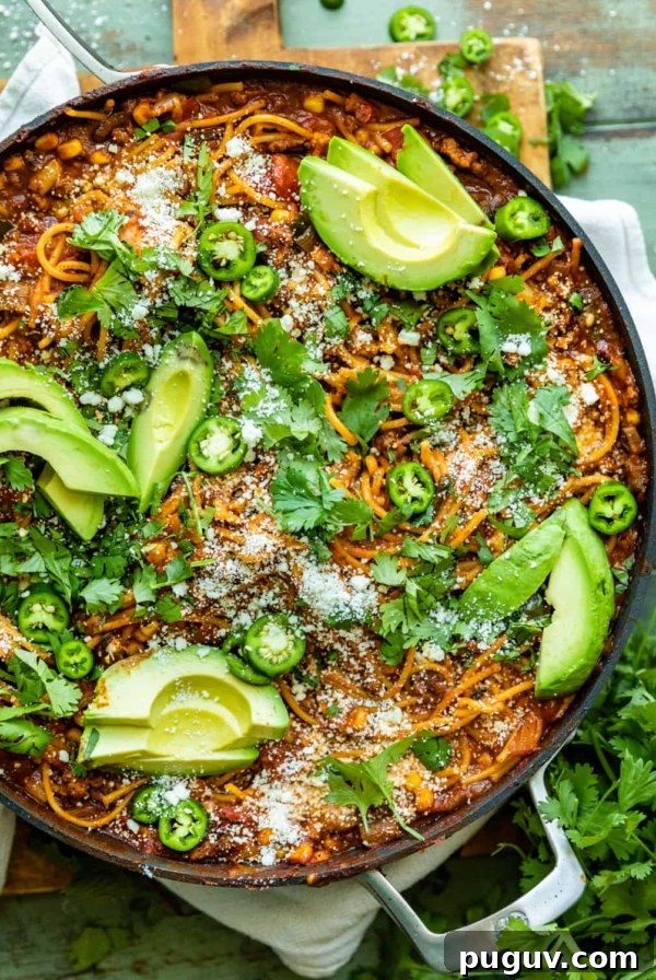 Mango Habanero Salsa Recipe — Sweet Heat with Fresh Mango 10 mexican spaghetti in a large skillet garnished with cotija, avocado, and cilantro.