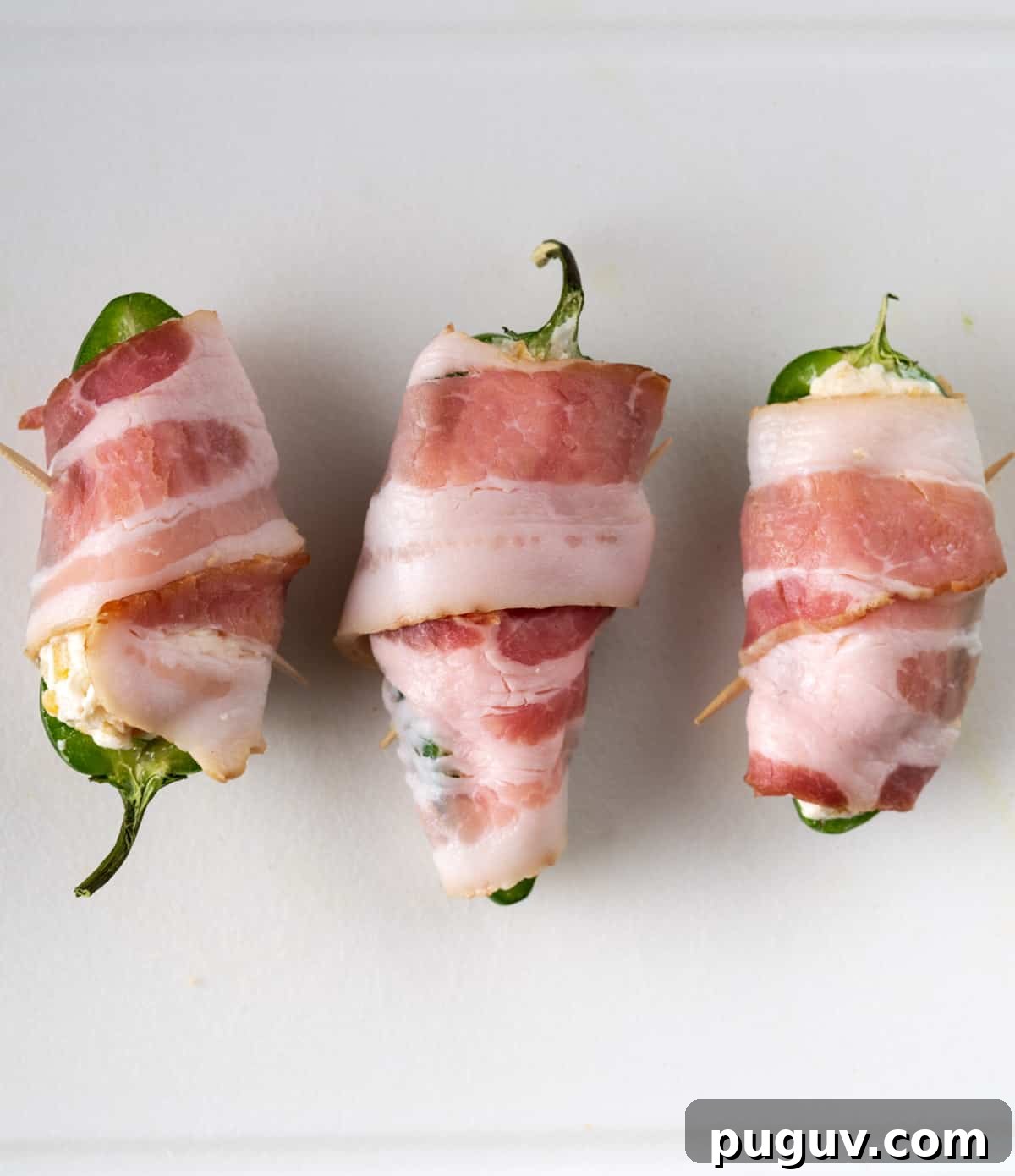 Crispy Air Fryer Jalapeño Poppers: Cream Cheese Stuffed Bites 8 Jalapeños stuffed with a cream cheese mixture and wrapped in bacon with a toothpick securing it
