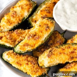 Crispy Air Fryer Jalapeño Poppers: Cream Cheese Stuffed Bites 10 a plate of air fryer jalapeño poppers with a white dipping sauce