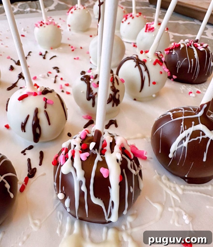 Red Velvet Cake Pops: Bite-Sized Dessert Recipe Guide 8 Cake balls on a parchment lined table.