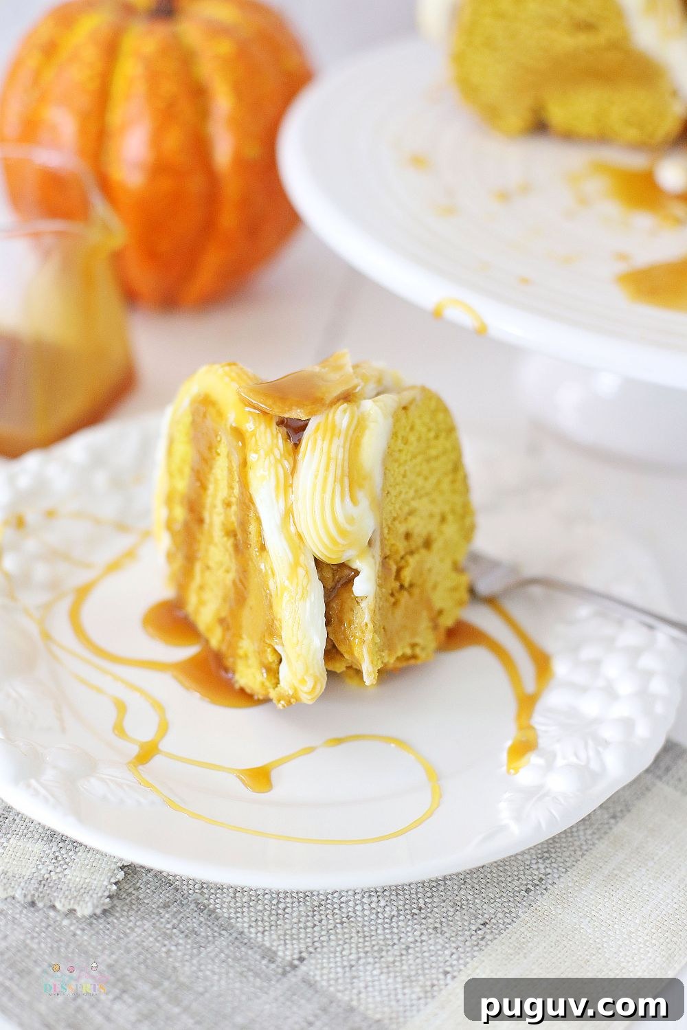 Fresh Pumpkin Bundt Cake with Creamy Buttercream Frosting 5 Image of a slice of pumpkin cake with fresh pumpkin, topped with buttercream frosting and drizzled with caramel sauce
