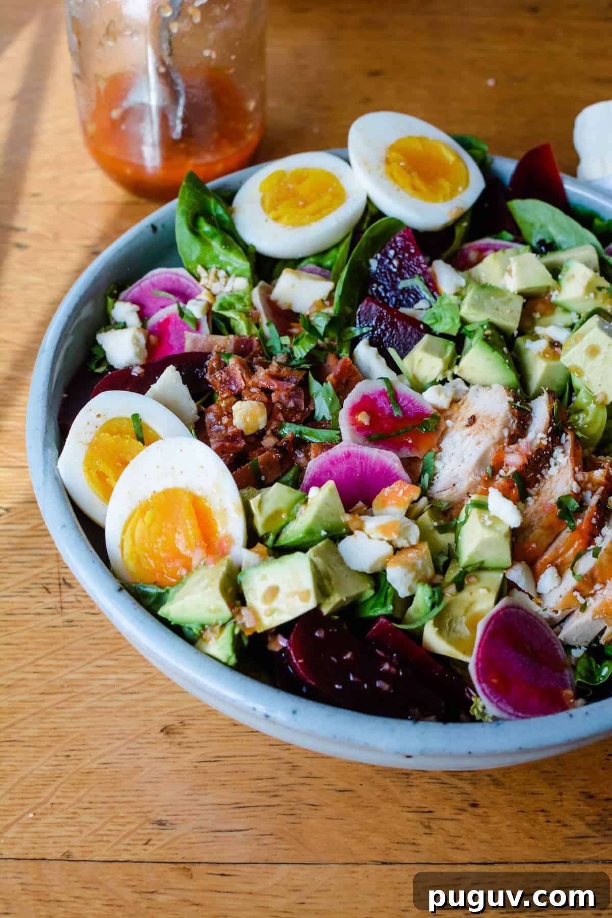 Autumn Harvest Cobb Salad with Cranberries, Apples & Goat Cheese 2 A large Cobb Salad recipe with hard boiled eggs, beets, chicken, and bright pink radishes.