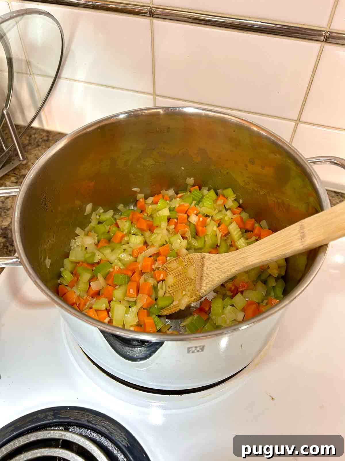 Classic Italian Wedding Soup Recipe — Authentic Homemade Flavor 6 vegetables bring sautéed in pot.