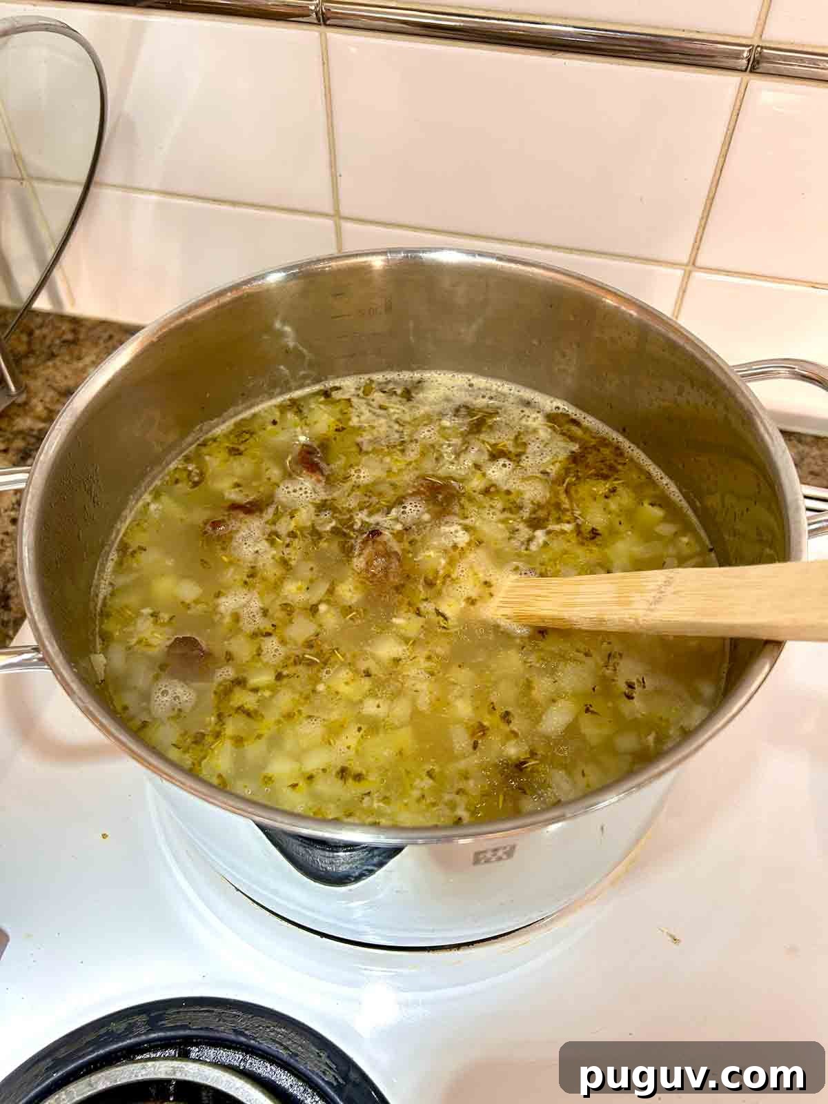 Classic Italian Wedding Soup Recipe — Authentic Homemade Flavor 8 meatballs added to pot.