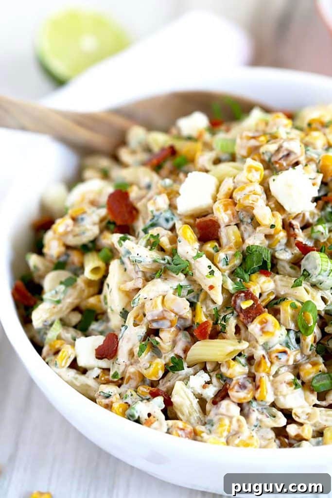Mexican Street Corn Pasta Salad Recipe with Chili-Lime Dressing 2 Close up view of Mexican Street Corn Pasta Salad in a white bowl.