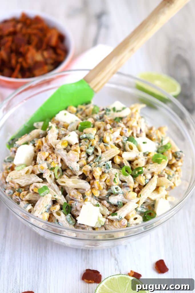 Mexican Street Corn Pasta Salad Recipe with Chili-Lime Dressing 9 mixing all the ingredients together
