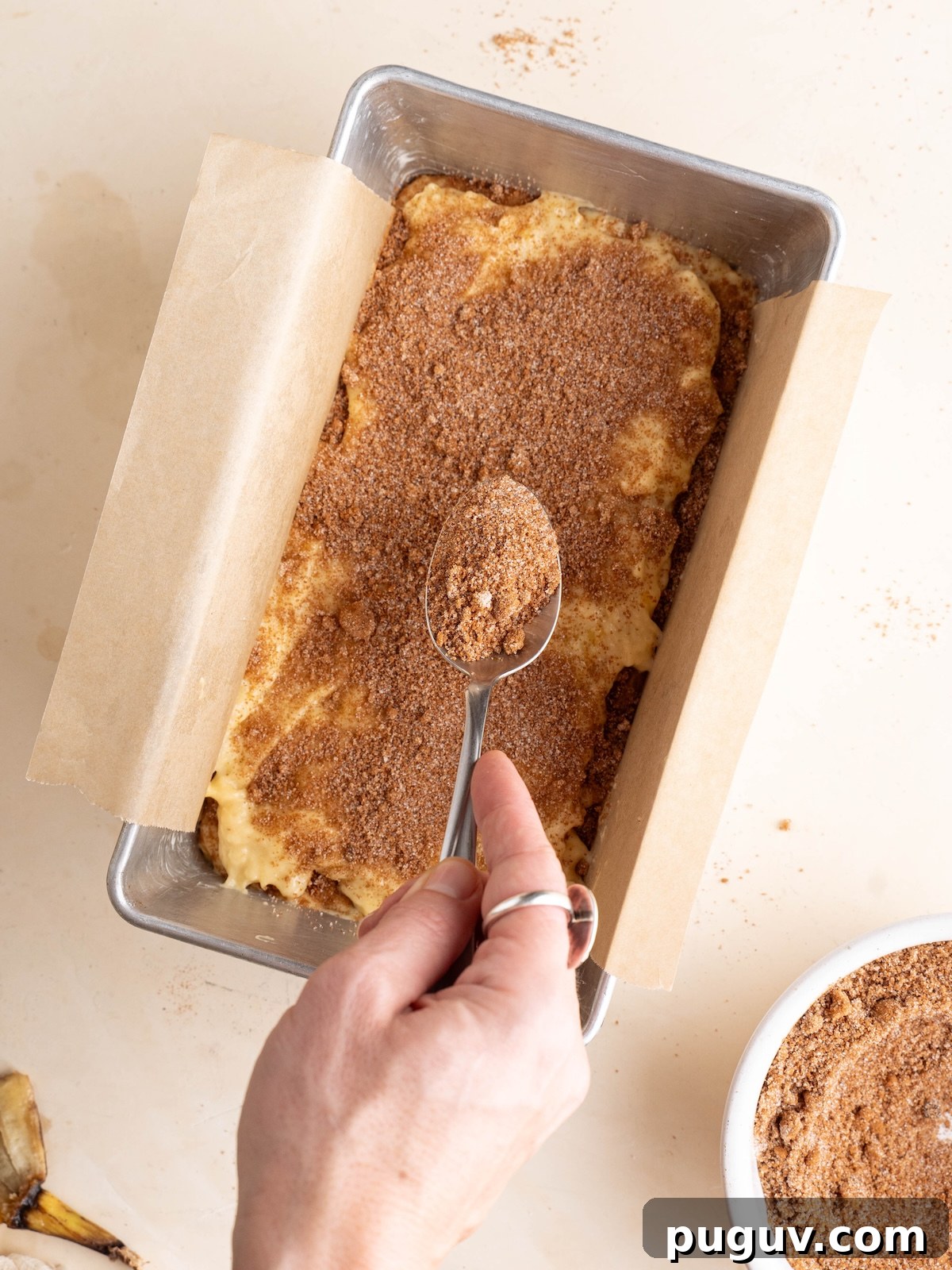 Cinnamon Swirl Banana Bread Recipe with Brown Sugar Swirl 3 Sprinkling cinnamon sugar layer over batter