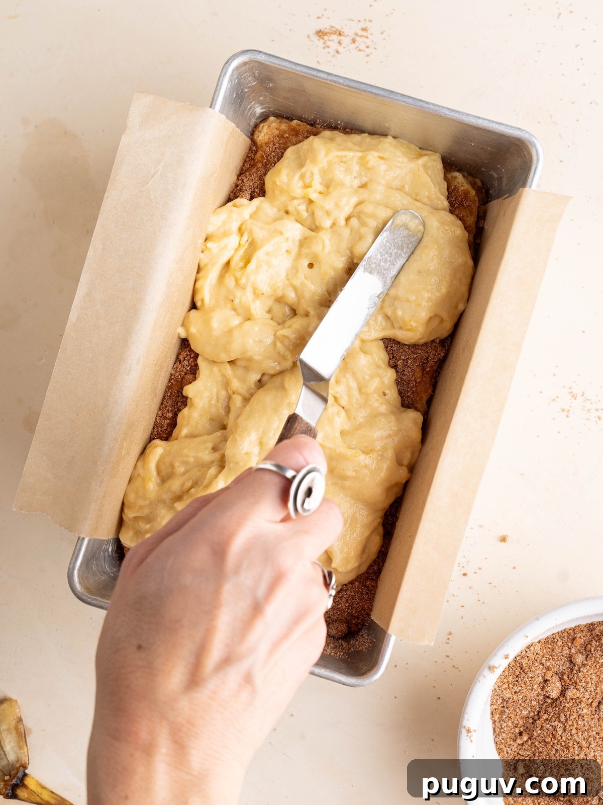 Cinnamon Swirl Banana Bread Recipe with Brown Sugar Swirl 4 Spreading banana batter over cinnamon sugar mixture