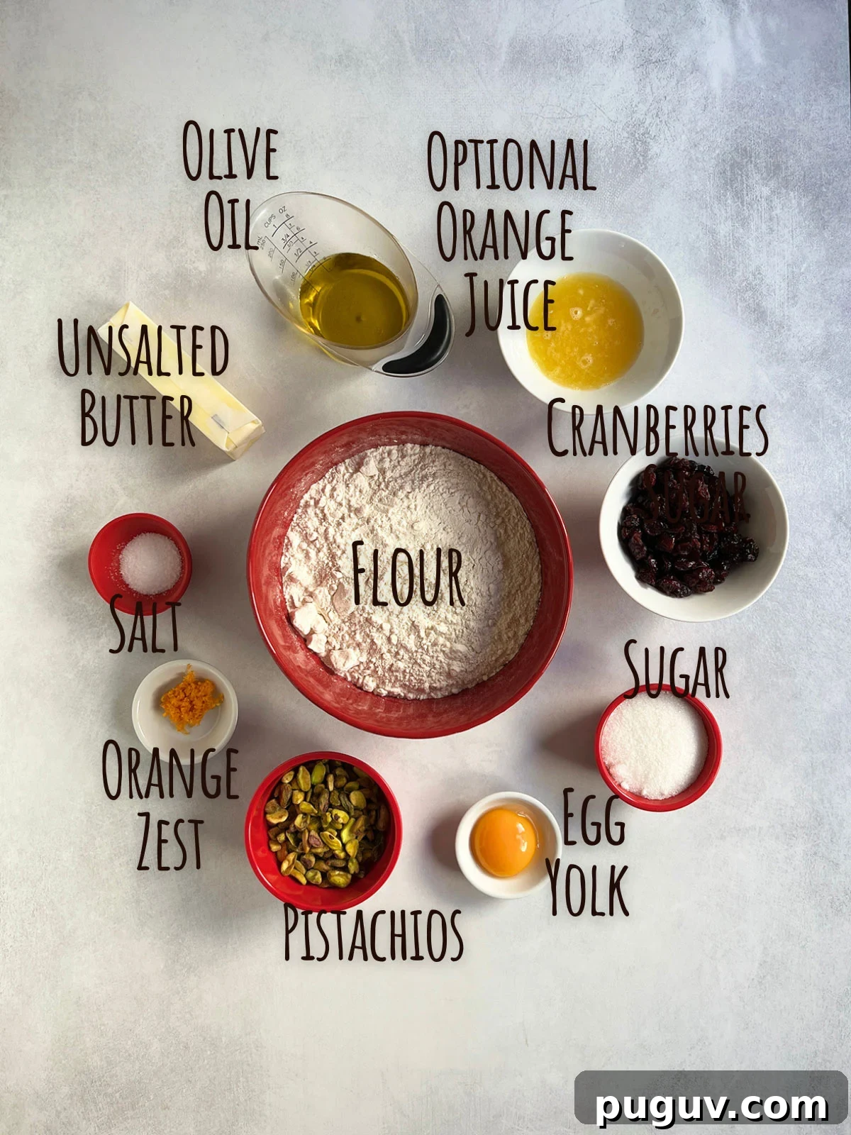 Ingredient shot for cranberry shortbread cookies showing flour in the center with other ingredients around the bowl.