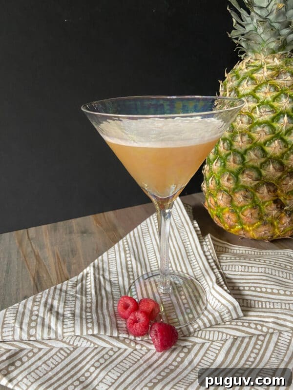 How to Make a Classic French Martini Cocktail 3 French martini cocktail next to a pineapple