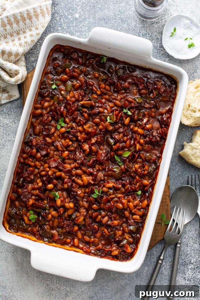 Classic Homemade Baked Beans Recipe for Oven-Baked Flavor 6 Beans with bacon in a baking dish.