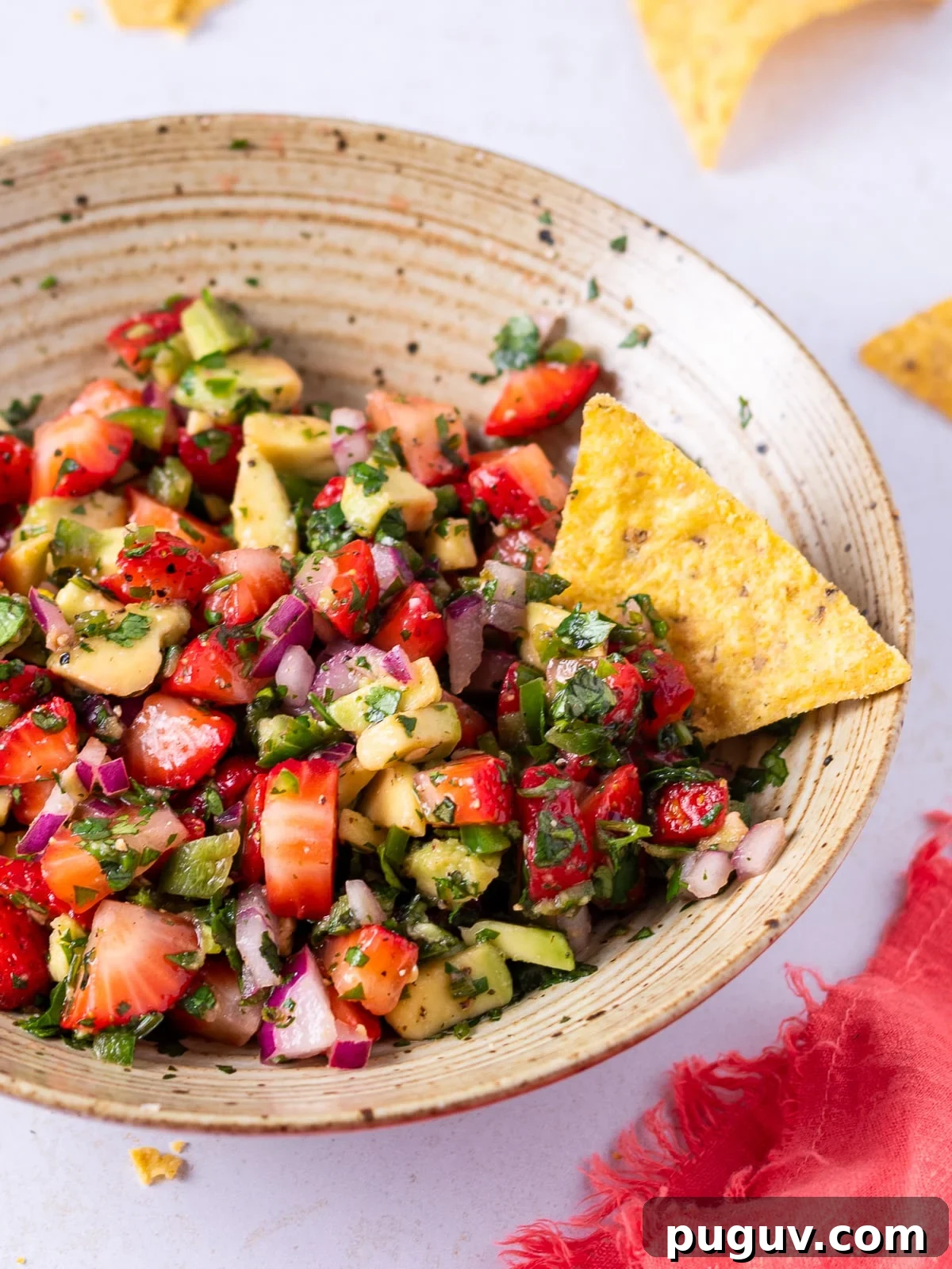 Strawberry Jalapeño Salsa Recipe — Fresh, Spicy Summer Dip 2 bowl of strawberry jalapeno salsa with a tortilla chip