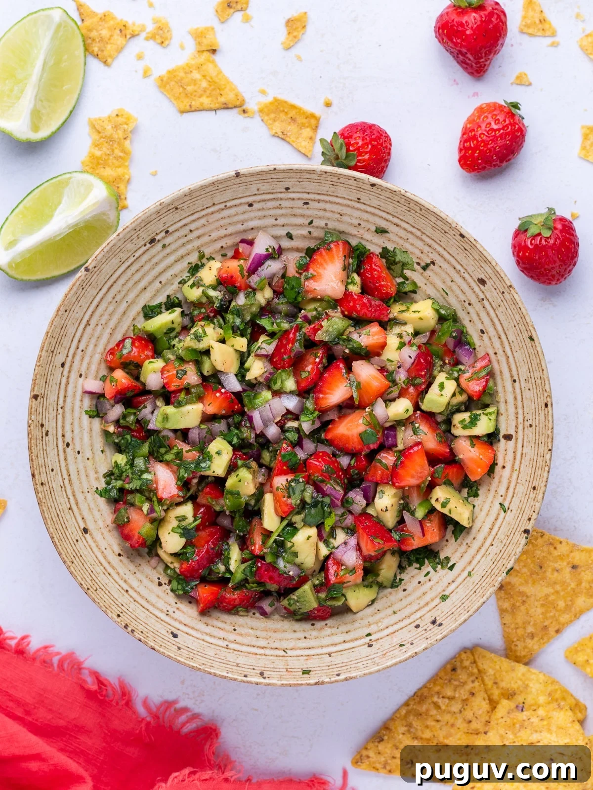 Strawberry Jalapeño Salsa Recipe — Fresh, Spicy Summer Dip 6 bowl of strawberry jalapeno salsa- chips, strawberries and lime slices surround the bowl