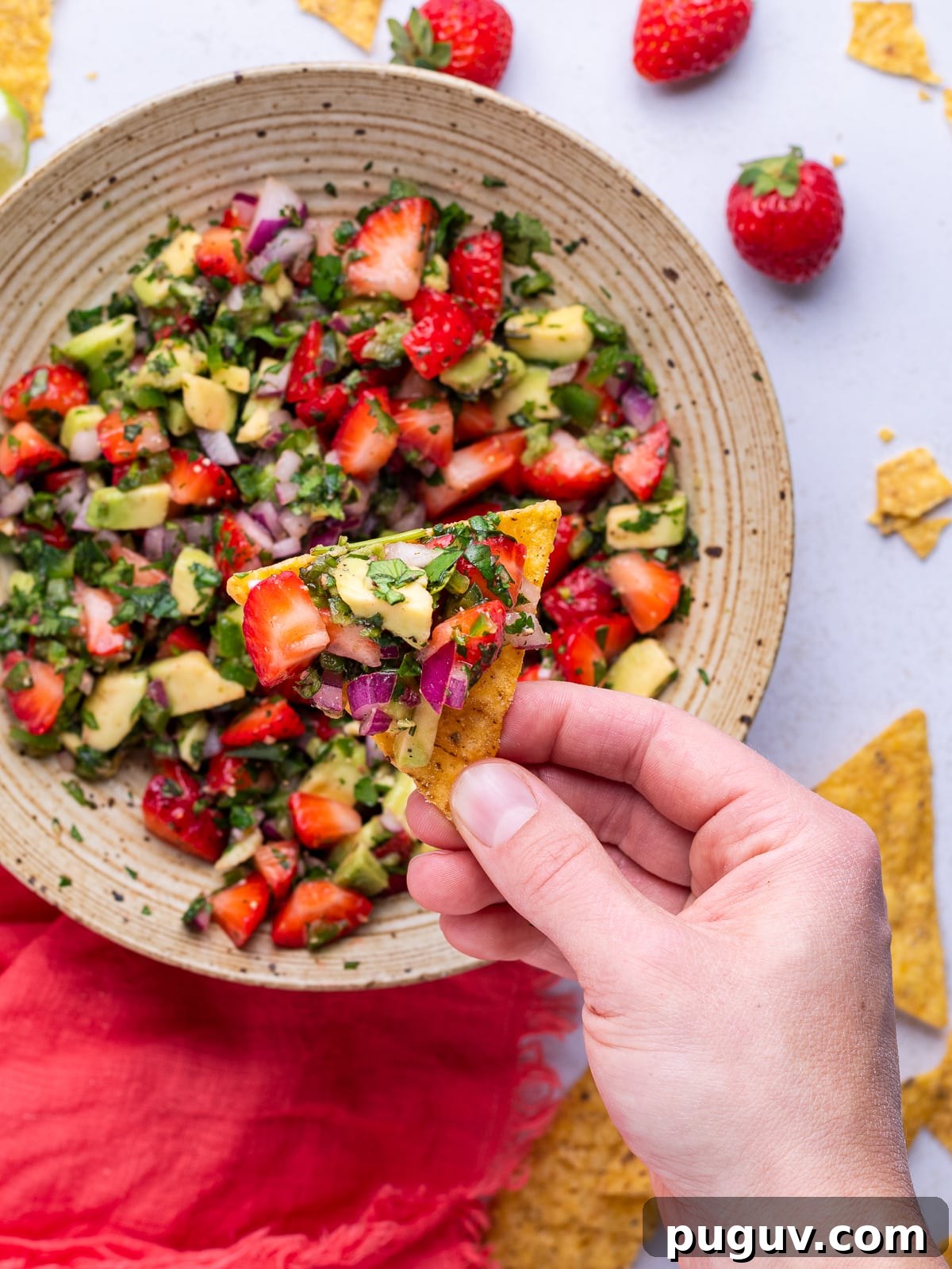 Strawberry Jalapeño Salsa Recipe — Fresh, Spicy Summer Dip 7 scooping a chip into strawberry salsa