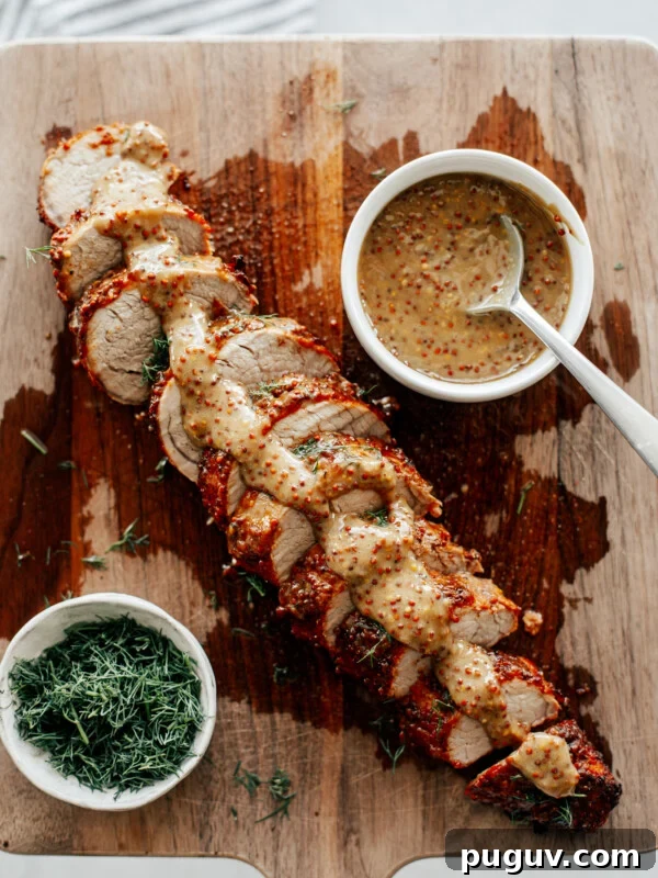 Crispy Air Fryer French Fries with 3 Ingredients 15 Sliced pork tenderloin on a wooden board drizzled with mustard sauce.