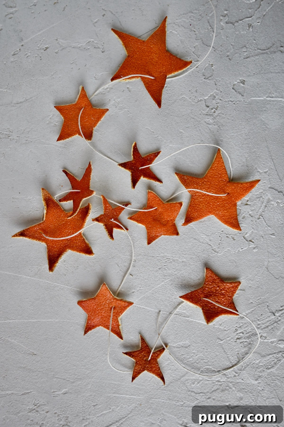 DIY Orange Peel Star Garland: Natural Holiday Decoration Tutorial 2 Orange Peel Star Garland strung up on twine, laid out and ready to be placed on a tree.