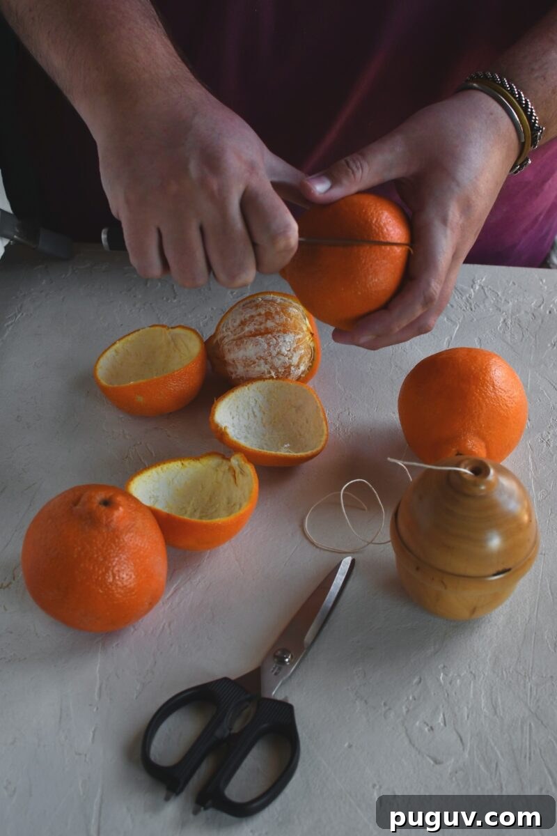 DIY Orange Peel Star Garland: Natural Holiday Decoration Tutorial 5 Gently slicing an orange to remove the peel only.