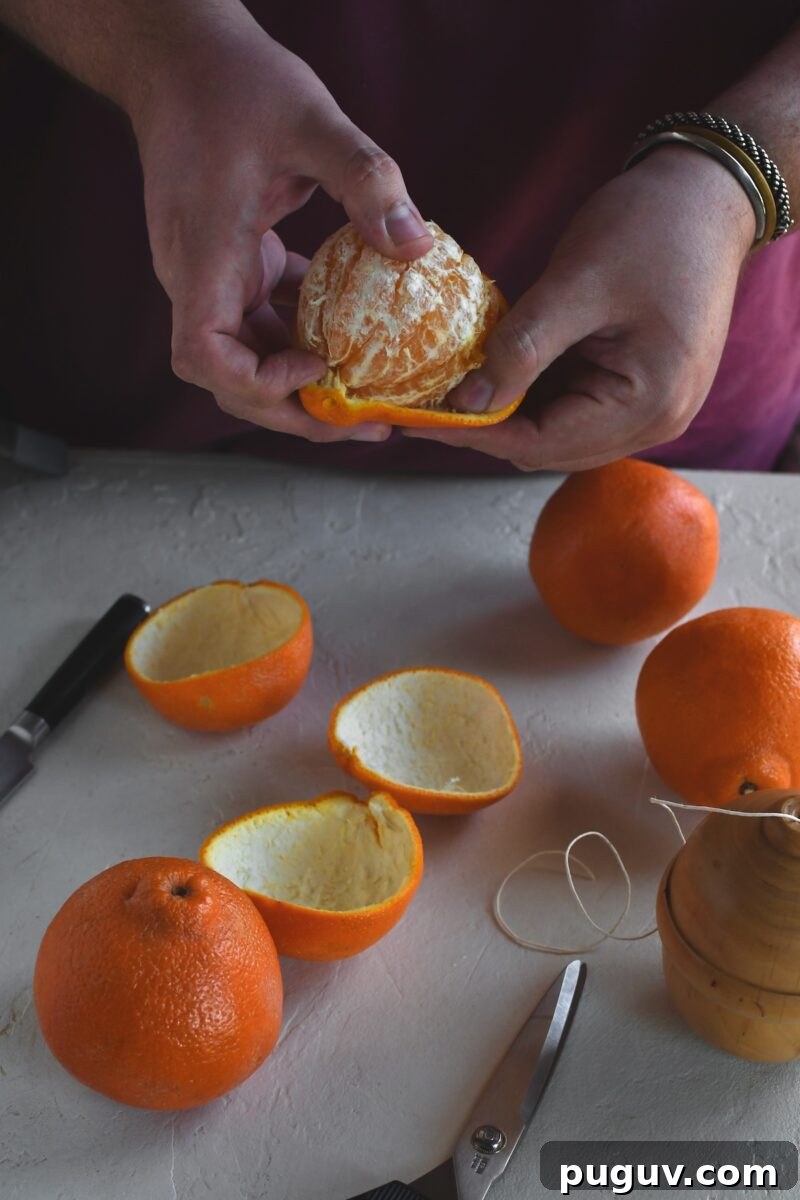 DIY Orange Peel Star Garland: Natural Holiday Decoration Tutorial 6 Gently removing the peel from an orange, keeping it intact in one large piece.