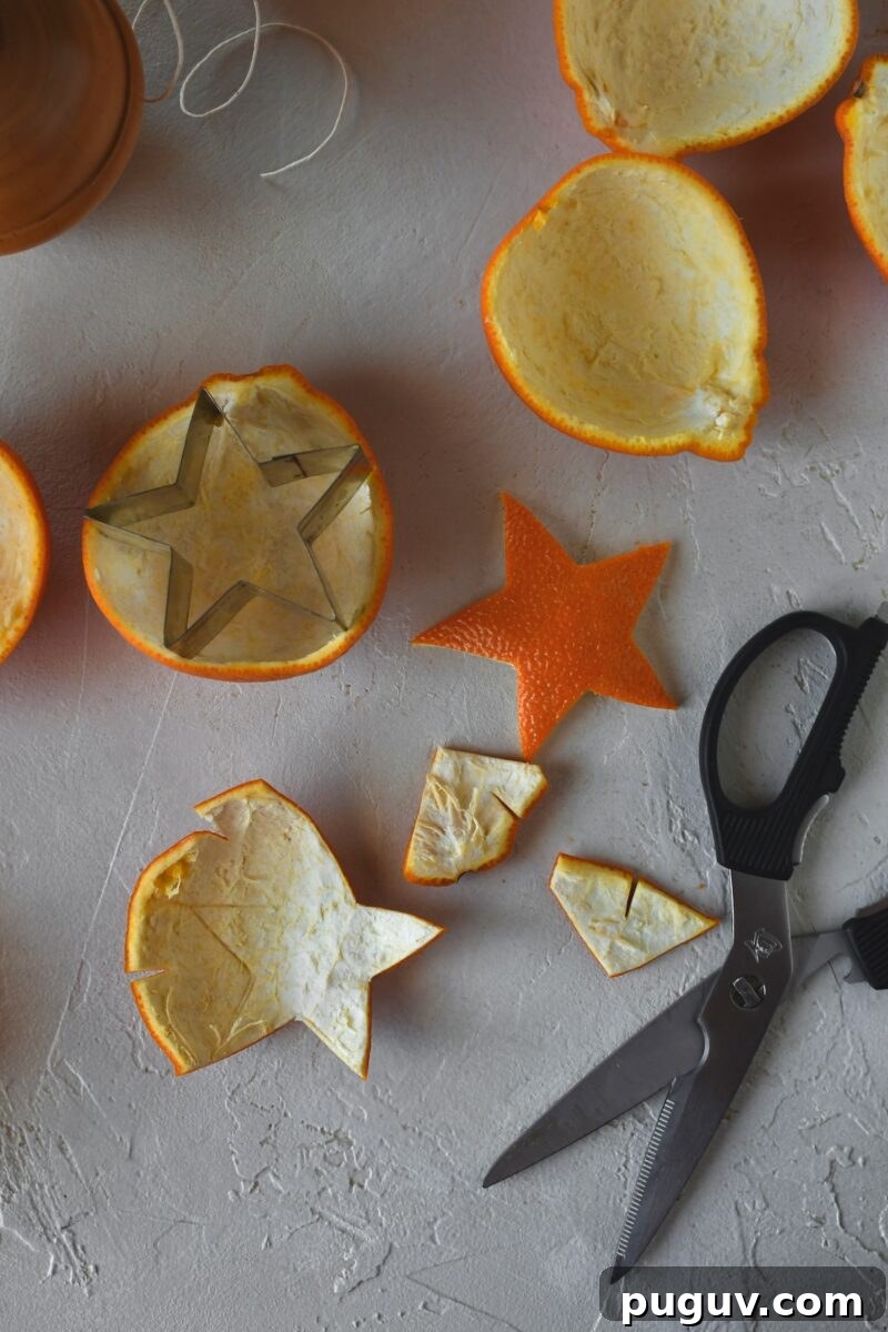 DIY Orange Peel Star Garland: Natural Holiday Decoration Tutorial 8 Using a star cookie cutter to score the orange peel, then using scissors to cut them out.