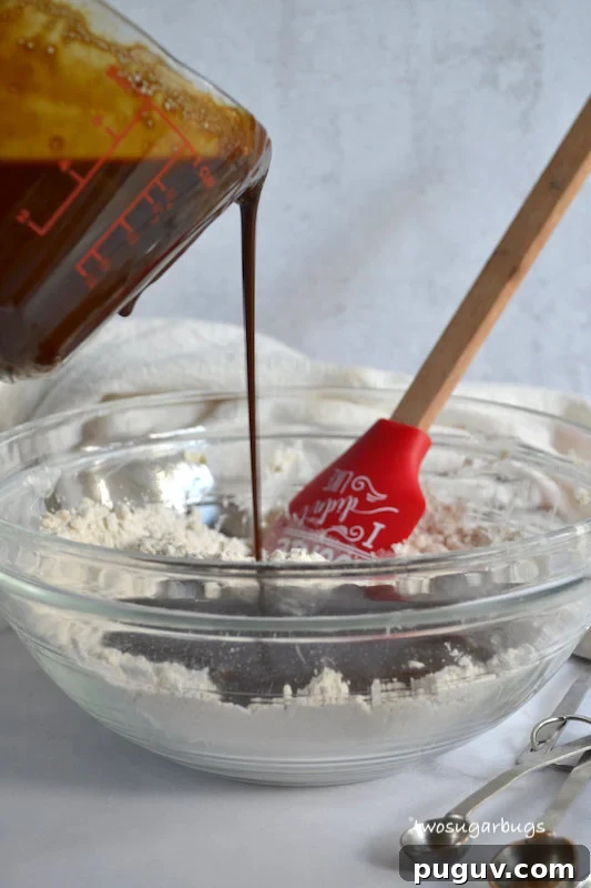 Wet ingredients being poured into dry ingredients