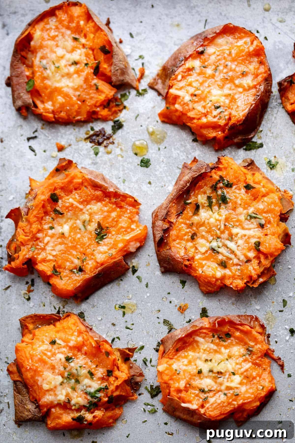 Garlic Butter Smashed Sweet Potatoes with Parmesan Crisps 2 Pieces of Garlic Butter Smashed Sweet Potatoes With Parmesan kept on baking paper
