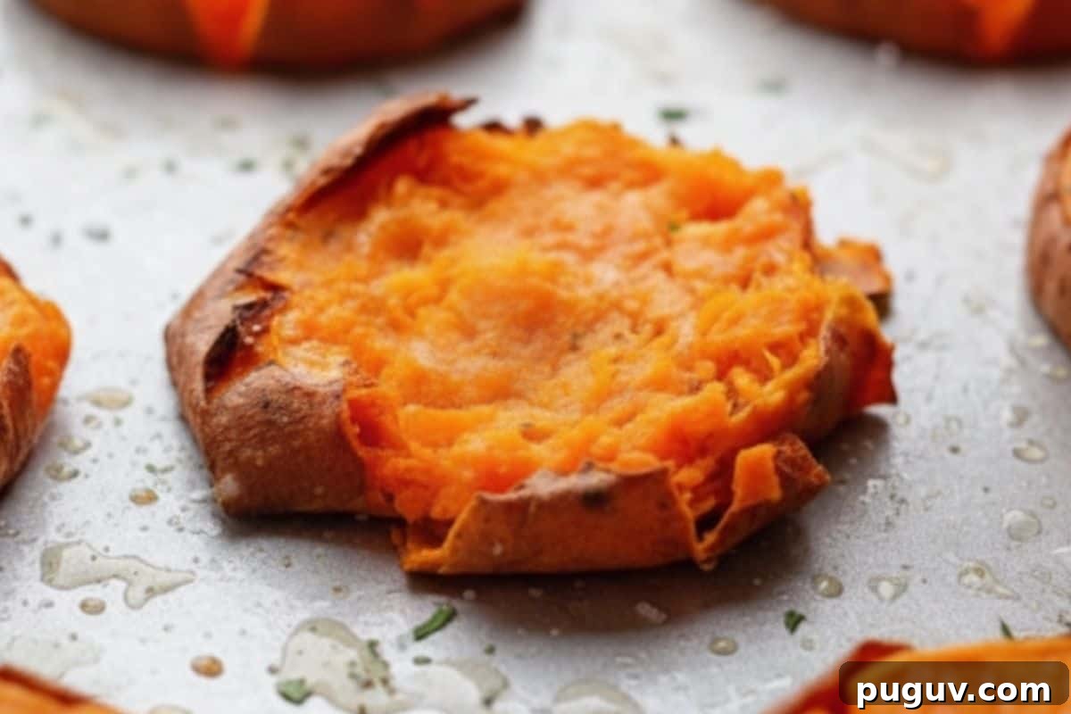 Garlic Butter Smashed Sweet Potatoes with Parmesan Crisps 6 Use a fork and gently press down each sweet potato until slightly flattened.