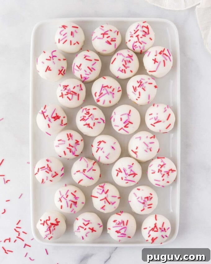 Valentine Sugar Cookie Truffles: Creamy Heart-Shaped Dessert Bites 11 tray of sugar cookie Valentine truffles with red and pink sprinkles