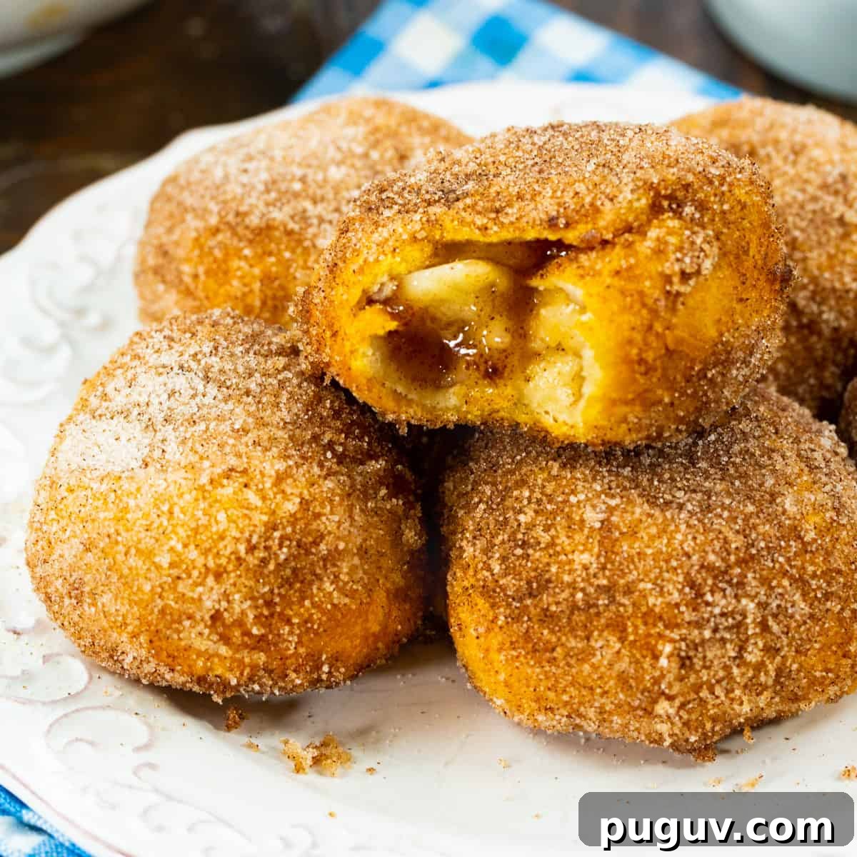 Air Fryer Apple Pie–Stuffed Biscuits: Quick Dessert Recipe 2 Air Fryer Apple Pie Stuffed Biscuits on a plate.