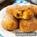Air Fryer Apple Pie–Stuffed Biscuits: Quick Dessert Recipe 8 Air Fryer Apple Pie Stuffed Biscuits on a plate.
