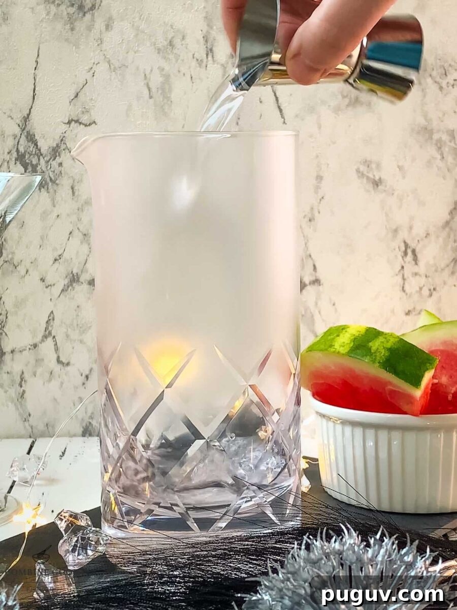 Refreshing Watermelon Martini Recipe: How to Mix the Perfect Cocktail 4 Adding vodka and dry vermouth into the stirring glass.