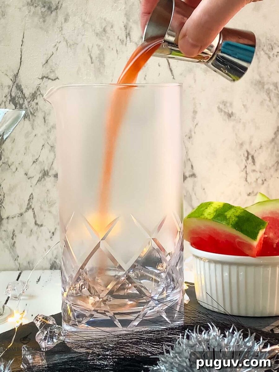 Refreshing Watermelon Martini Recipe: How to Mix the Perfect Cocktail 5 Adding homemade watermelon syrup into the stirring glass.