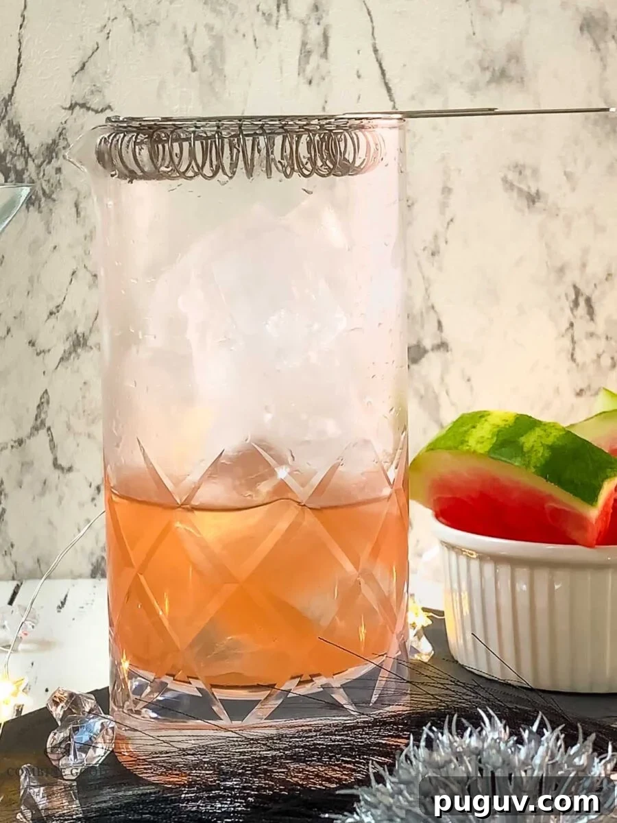 Refreshing Watermelon Martini Recipe: How to Mix the Perfect Cocktail 8 The hawthorn strainer is placed on top of the stirring glass.