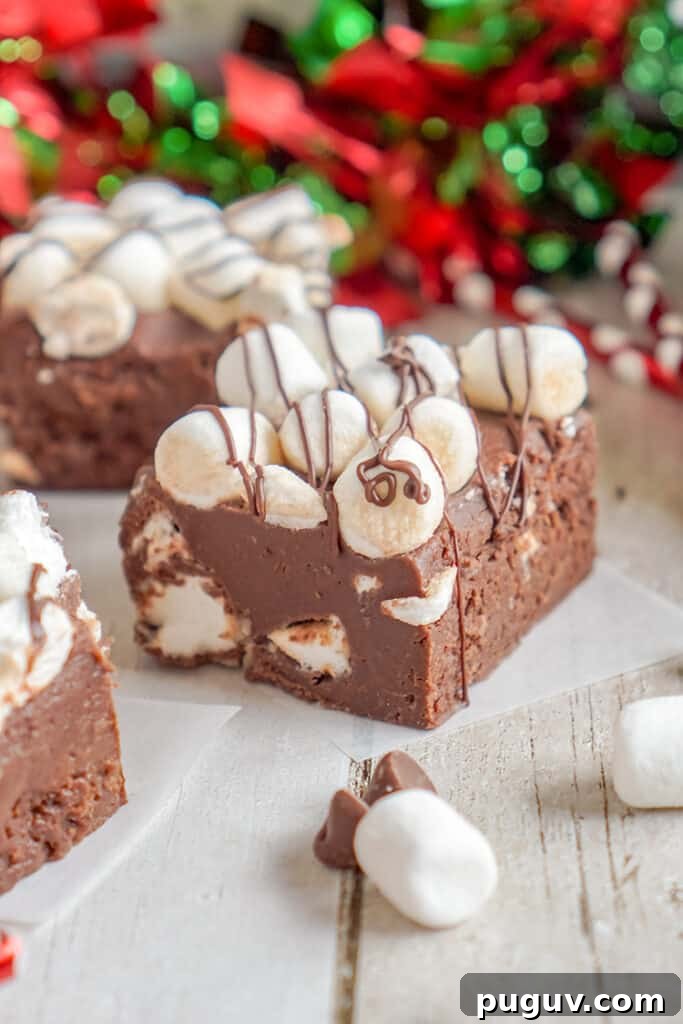 Decadent Hot Chocolate Fudge Recipe for Rich Cocoa Lovers 2 fudge on pieces of parchment paper with red and green ribbon behind it