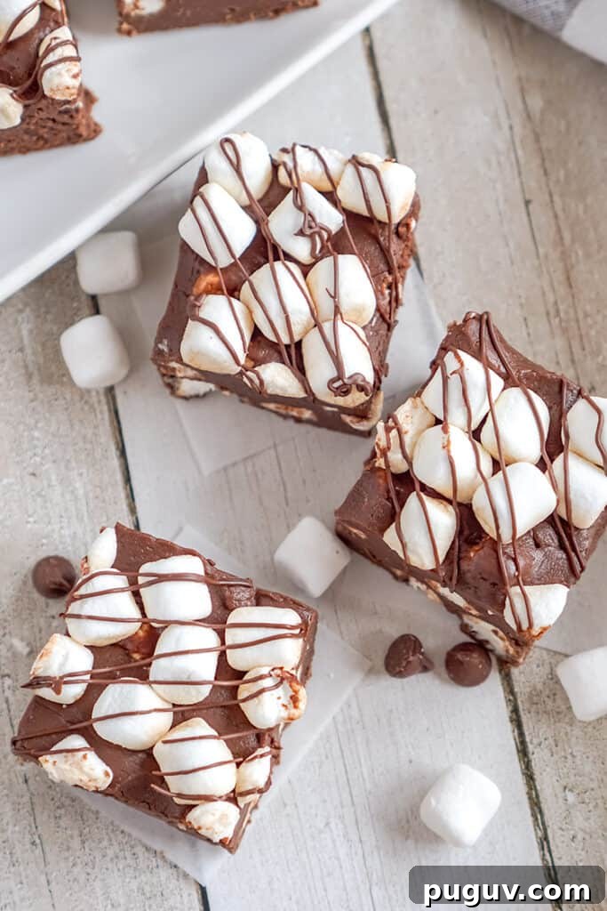 Decadent Hot Chocolate Fudge Recipe for Rich Cocoa Lovers 3 overhead photo of hot cocoa fudge on wax paper and mini marshmallows around the fudge