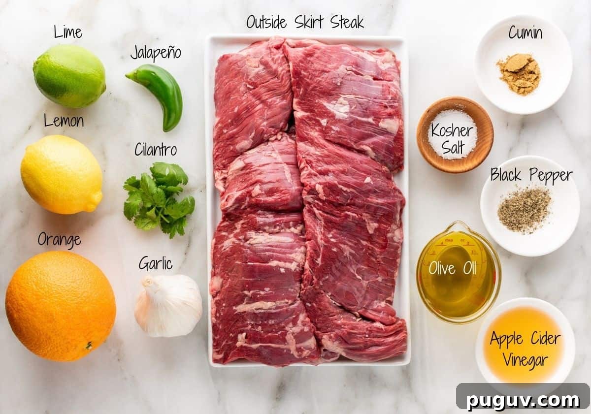 Carne Asada in the oven Ingredients on a white marble board.