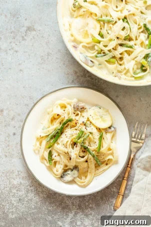 Vegan Lemon Asparagus Pasta - 30 mins! Creamy Lemon Alfredo style sauce with tofu with fettuccine and pan roasted garlic asparagus and more lemon. #Vegan #Nutfree #Recipe. Can be Glutenfree #VeganRicha #LemonAsparagusPasta 17 gm of protein