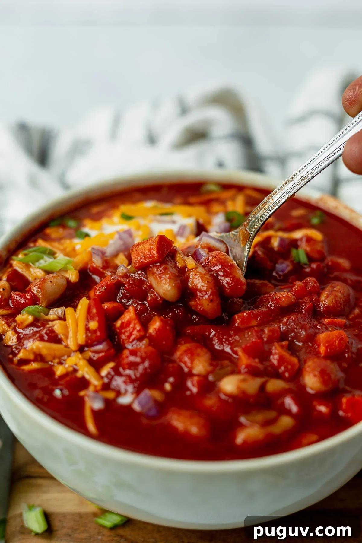 Smoky White Bean Vegetarian Chili — Slow Cooker Recipe 4 spoon scooping out a bite of slow cooker vegetarian chili