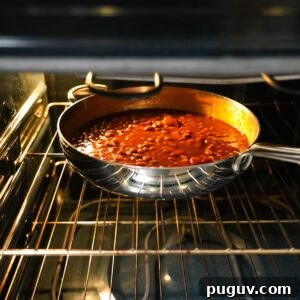 Classic Oven-Baked Beans Recipe with Step-by-Step Video 11 Baked beans cooking in the oven.