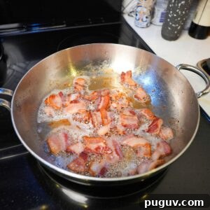 Classic Oven-Baked Beans Recipe with Step-by-Step Video 7 Bacon cooking in a pan.