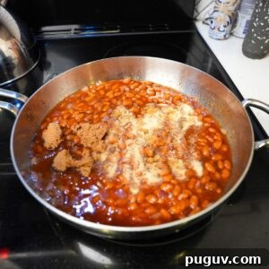 Classic Oven-Baked Beans Recipe with Step-by-Step Video 9 Baked beans with seasonings on top.