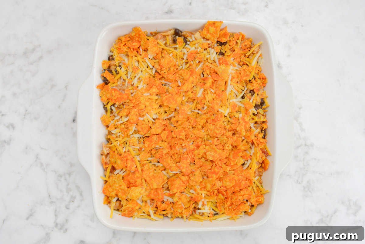 Doritos Casserole Recipe with WW SmartPoints and Tips 12 A white square baking dish filled with casserole mixture is topped with bright orange Doritos pieces