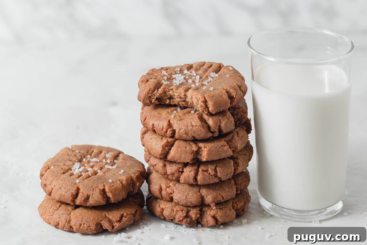 Keto Peanut Butter Cookies – 4-Ingredient Low-Carb Recipe 3 keto peanut butter cookies with a glass of milk