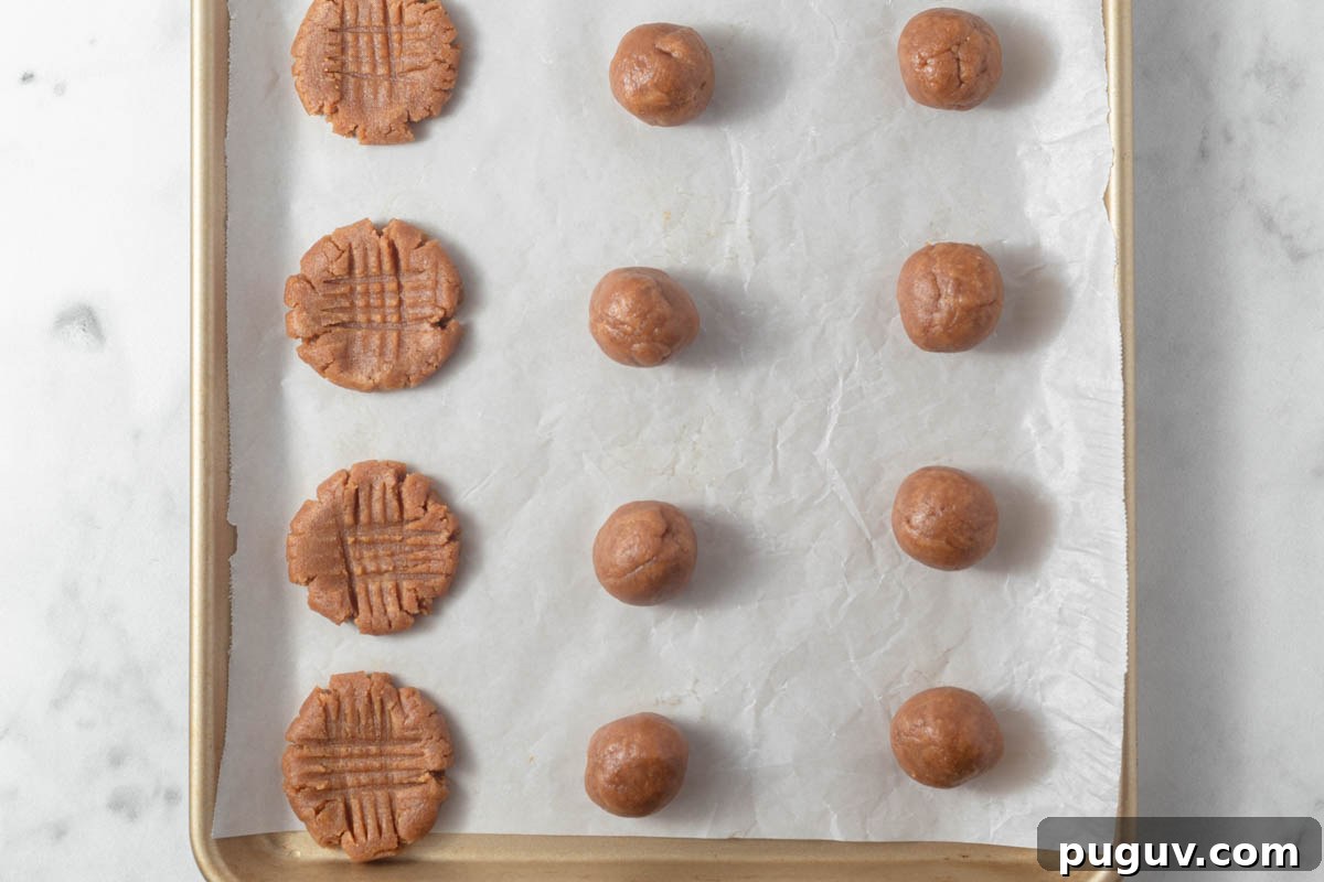 Keto Peanut Butter Cookies – 4-Ingredient Low-Carb Recipe 5 Keto peanut butter cookie dough ball on the baking sheet