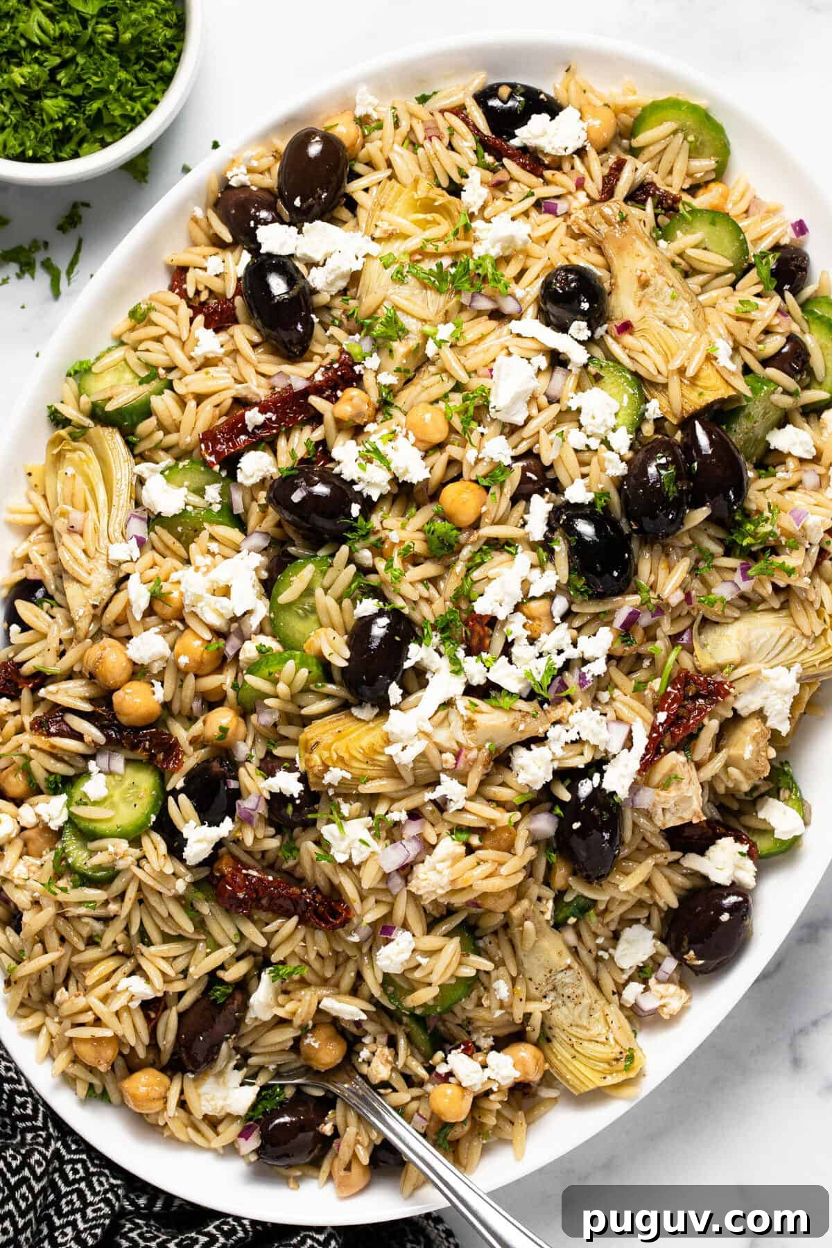 20-Minute Greek Orzo Salad with Feta & Olives 2 Large white platter filled with Greek orzo pasta salad