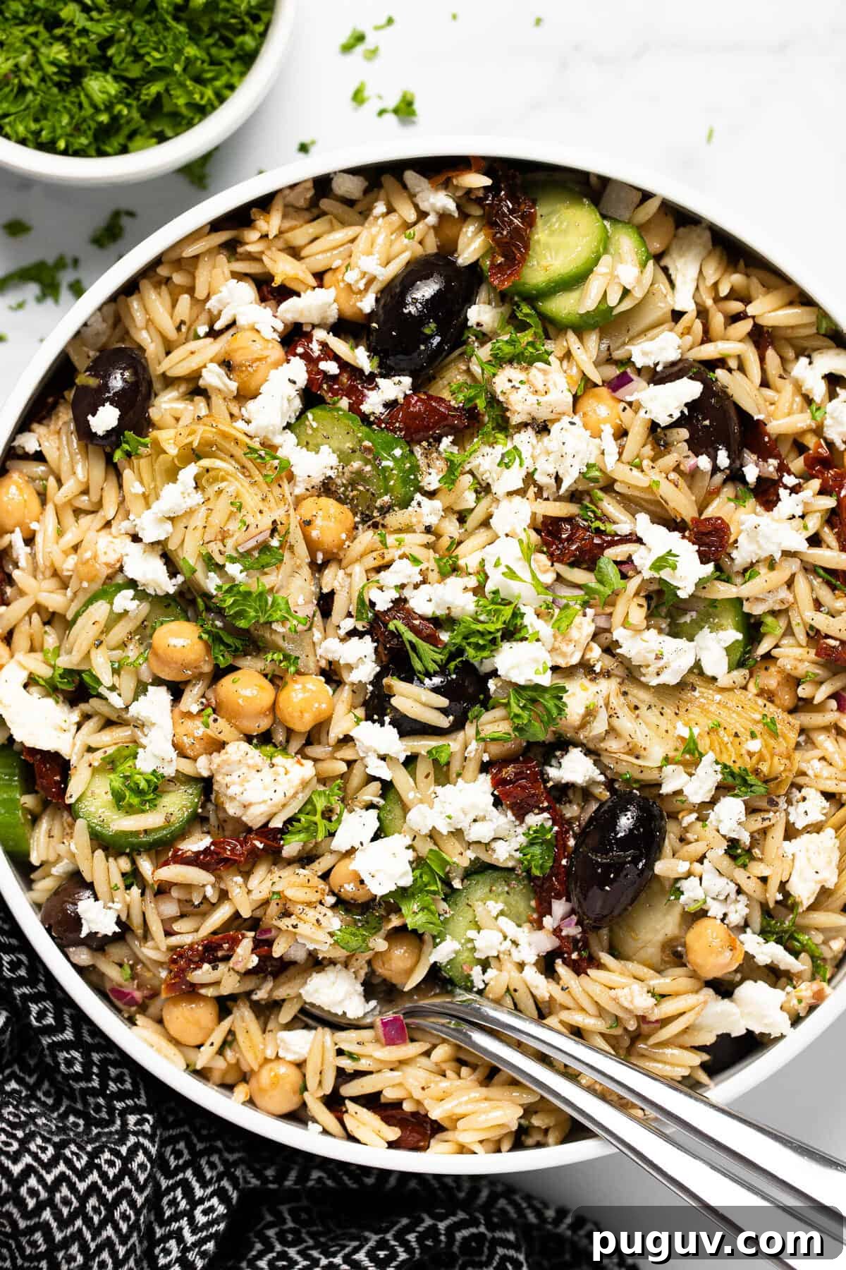 20-Minute Greek Orzo Salad with Feta & Olives 4 Large white bowl filled with Greek pasta salad garnished with parsley