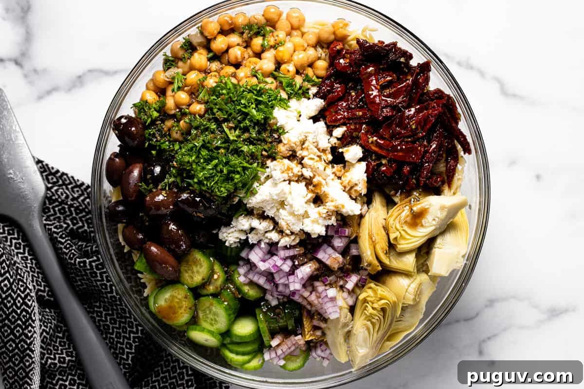 20-Minute Greek Orzo Salad with Feta & Olives 6 Glass bowl filled with ingredients to make Mediterranean pasta salad