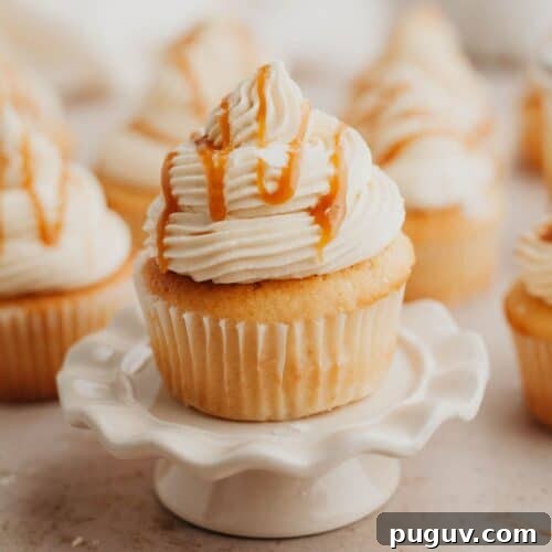 Caramel filled cupcakes, the one at the front is on a small cupcake stand.