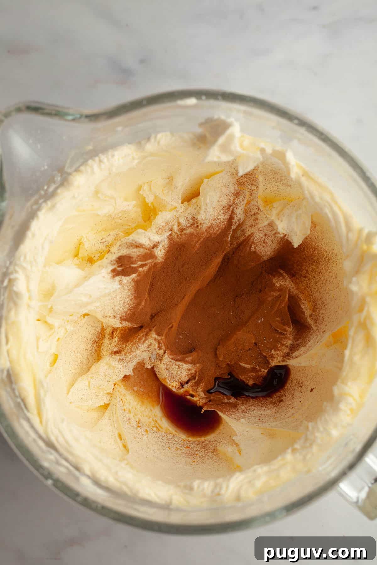 A large mixing bowl with creamed butter, sugar and espresso powder.
