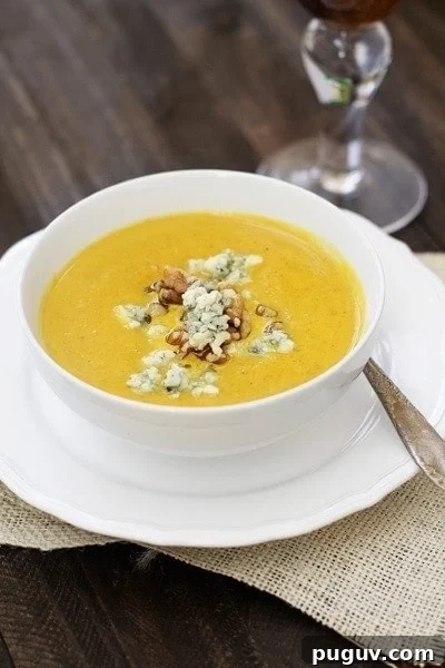 Creamy Pumpkin Soup with Toasted Walnuts and Crispy Toast 3 Photo of easy pumpkin soup made with canned pumpkin in a white bowl.